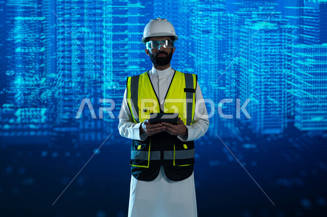 متابعة المخططات الهندسية المتطورة، الحداثة والإبتكار والتطور في الهندسة المعمارية الذكية، مهندس عربي خليجي سعودي يرتدي نظارة الواقع الافتراضي ويستخدم التابليت، خلفية هولوجرامية ثلاثية الأبعاد للأبراج وناطحات السحاب السعودية، رؤية مستقبلية 2030