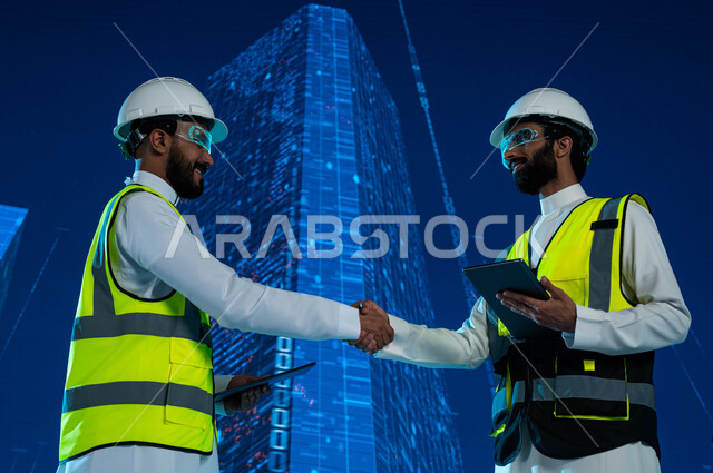 التصاميم الهندسية للمشاريع المستقبلية، تعاقدات واتفاقيات عمل سعودية ناجحة مع شركات هندسية متطورة، مهندسان عربيان خليجيان سعوديان يرتديان نظارة الواقع الإفتراضي ويتصافحان، خلفية هولوجرامية ثلاثية الابعاد للابراج وناطحات سحاب السعودية، رؤية مستقبلية 2030