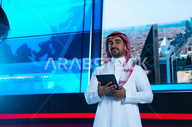 Talking about prosperity and urban development, a Saudi Arabian Gulf broadcaster and media presenter presenting the newsletter, reading the news brief using the tablet, the architectural engineering art of the towers and skyscrapers, an electronic wallpap