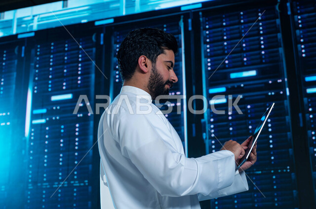 The concept of cloud storage technology, a 3D holographic background for the servers control room and internet servers, a Saudi Arab Gulf man using a tablet to supervise and manage data center information, investing Saudi expertise in building advanced an