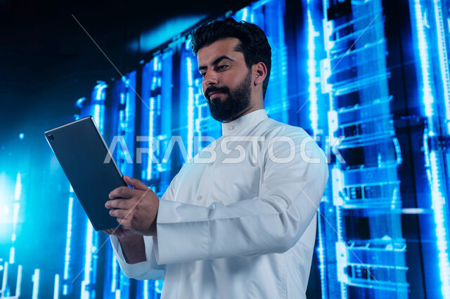 3D hologram background of the server room and servers, a Saudi Arabian Gulf man using a tablet to supervise and manage the data and information of the data center, the concept of cloud storage technology, investing Saudi expertise in building advanced and
