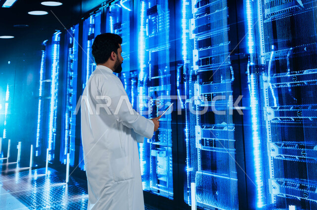 Investing Saudi expertise in building advanced and modern data centers, a Saudi Arabian Gulf man using a tablet to supervise and manage the data and information of the Data Center, the concept of cloud storage technology, a 3D hologram background for the 