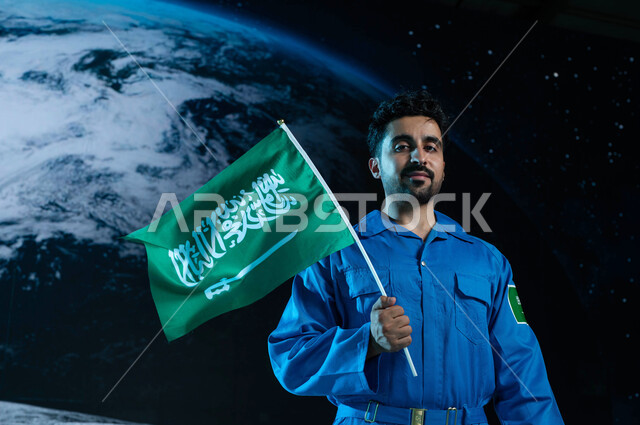 3D hologram background of the planet Earth, looking at the camera, Saudi Arabia's journey towards the outside world, a Saudi Arab Gulf astronaut wearing a Saudi space suit holding the flag of the Kingdom of Saudi Arabia in outer space, Saudi astronauts