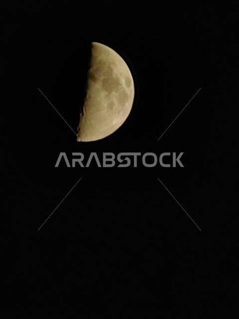 Semicircular gibbous moon, close-up of the incomplete moon in the night sky, against a black background