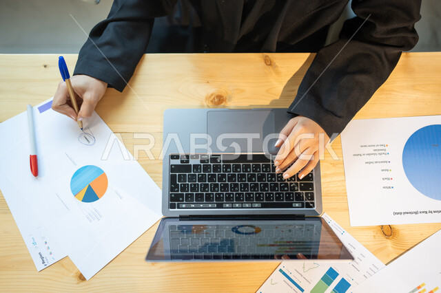 Developing a business strategy and growth plan, a vertical close-up of an employee performing work tasks using a computer, the analysis and statistical department, monitoring the economy and financial information, the company's profit and loss data.