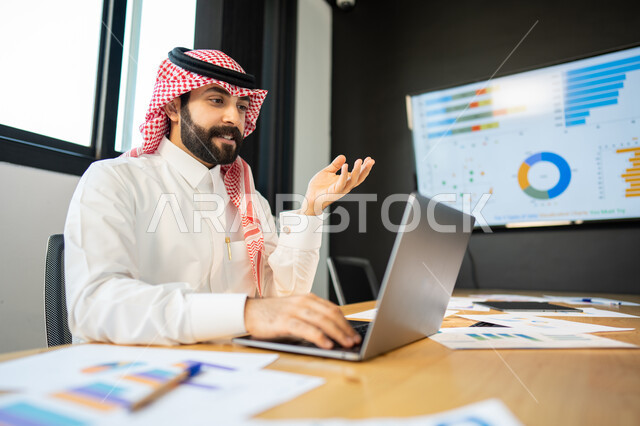 Explanation and discussion of remote work tasks, face and hand gestures indicating integration and focus, data on the company’s losses and profits, a Saudi Arabian Gulf employee wearing the traditional Saudi dress, communicating with customers by making a