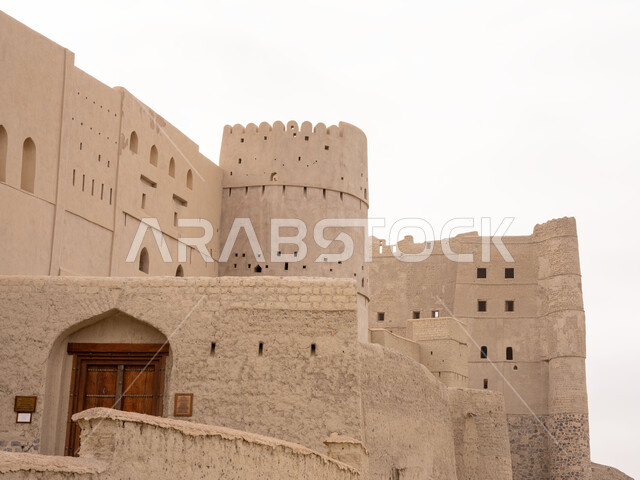 Design and architectural engineering in the old engineering style, an important strategic location, a view of the cloudy sky, Bahla Ibri Castle built of mud in the Sultanate of Oman, a military, historical, archaeological landmark, famous heritage tourist