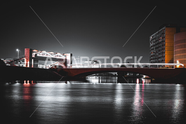 The waterfront bridge in the port of Jeddah at night time, shopping malls and shops on the Jeddah Corniche in the Kingdom of Saudi Arabia, famous landmarks and tourist areas, commercial towers and buildings in the historical Al-Balad area, infrastructure 