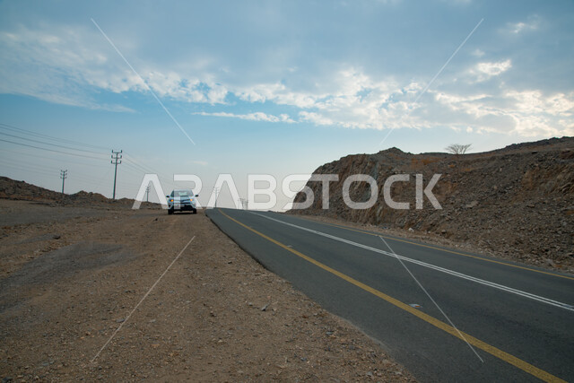 Car traffic in the streets and paved roads, means of transportation, mountain peaks and heights, landscapes in desert areas and sand dunes in the Kingdom of Saudi Arabia, hills and plateaus in mountainous areas, nature background