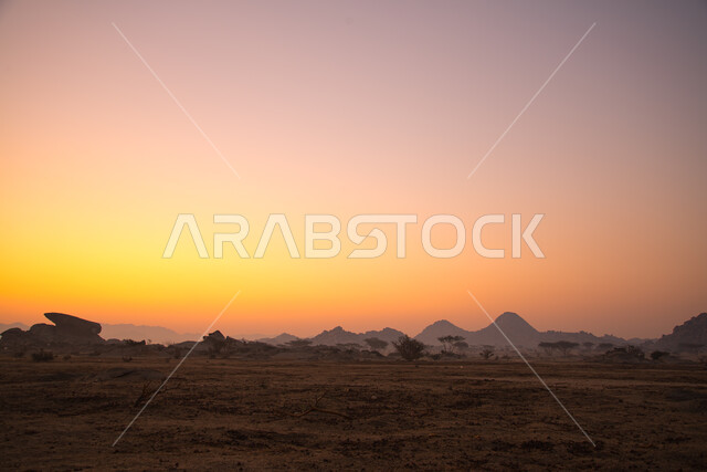 Nature background, sunset view in mountainous areas, desert scenery, mountainous nature, sand dunes, rocky stones and hills in the Kingdom of Saudi Arabia