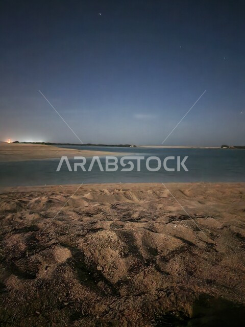 A night picture of the seashore in the city of Doha in the State of Qatar, soft beach sand and marine nature, tourist attractions and places in Qatar, nature background