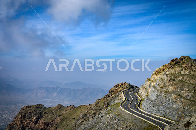 Rock formations and mountain heights, a panoramic view of the sky above the mountain range in the city of Taif, western Saudi Arabia, a mountain pass located in the city of Taif, famous tourist places.