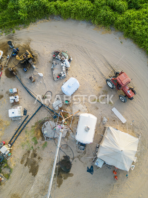 صورة علوية عامودية لأدوات ومعدات الزراعة، الأشجار والنباتات الخضراء في مزارع المملكة العربية السعودية، إستخدام الأدوات الزراعية، الزراعة في السعودية