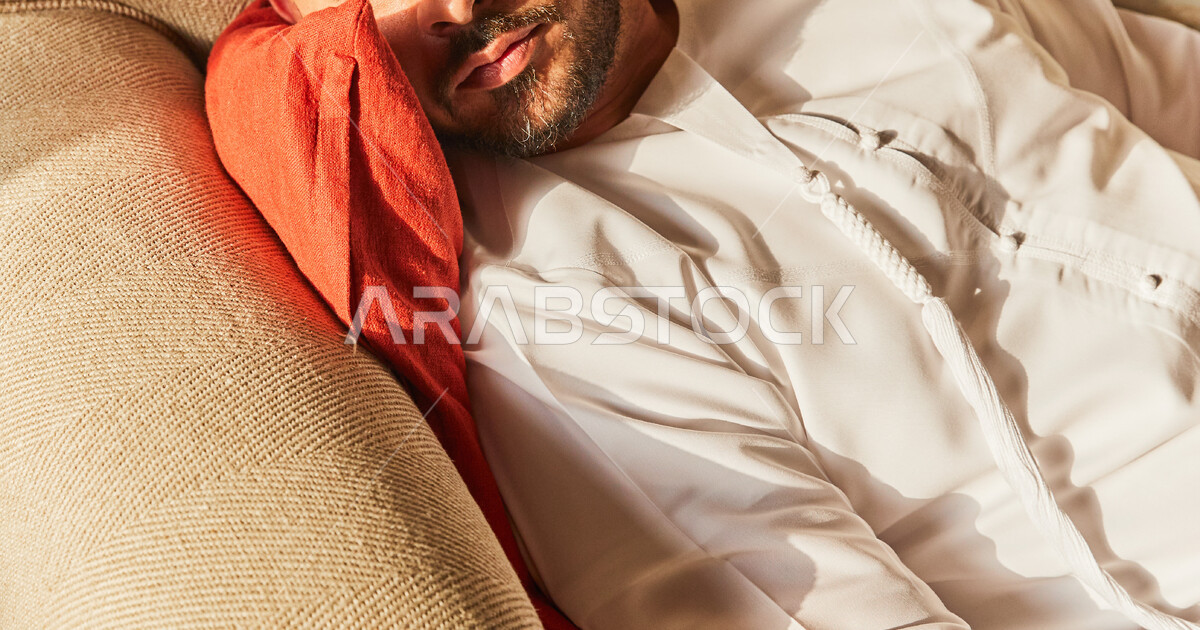 Absent-mindedness and looking at something, an Emirati Arab man wearing ...