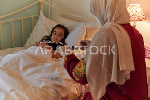 الإلتزام بالأوقات الصحيحة لأخذ الدواء، معاناة الأطفال أثناء مرضهم وأهمية استخدام الدواء بوصفه طبيه، اعتناء الأم بابنائها بحذر والوقاية لتجنب العدوى، طفله عربيه خليجيه إماراتية تعاني من المرض تقوم بتلقي الشراب المناسب من والدتها.