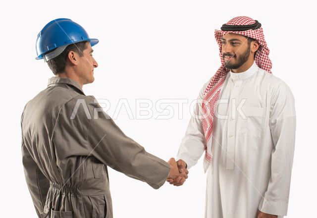 Working in the engineering sector, agreeing to complete work tasks, a close-up portrait of a smiling Saudi Gulf Arab man wearing a traditional thobe and shemagh shaking hands with an electrical engineer, a tinsmith worker wearing a protective helmet, getting to know each other and building social relationships, Saudi professions and jobs, white background
