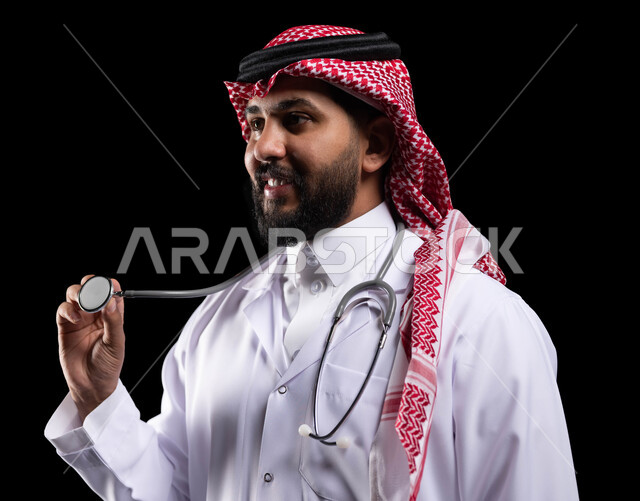 Saudi jobs and professions, conducting the necessary examinations, providing medical services and consultations, the concept of medicine and health care, a close-up portrait from the side of a smiling Saudi Arabian Gulf doctor wearing a traditional uniform and medical coat, using a stethoscope to hear the heartbeat, black background