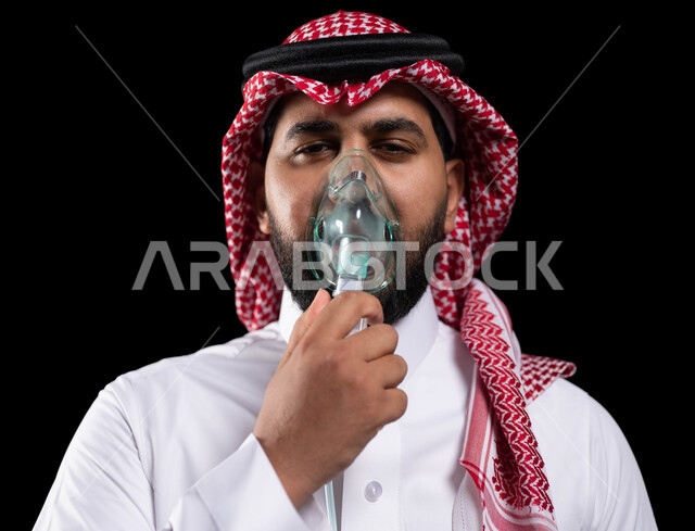 Treating chronic asthma diseases, maintaining a regular airway using a respirator, a close-up portrait of a Saudi Gulf Arab man wearing a shemagh and traditional dress, inhaling cough medicines, providing home health services to the patient, black background