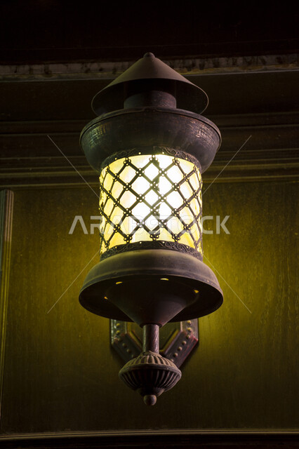 Celebrating the advent of the holy month of Ramadan, a close-up of a luminous and hanging traditional Arab metal lantern, Ramadan decorations, lights and decorations, preparing for the holy month of Ramadan