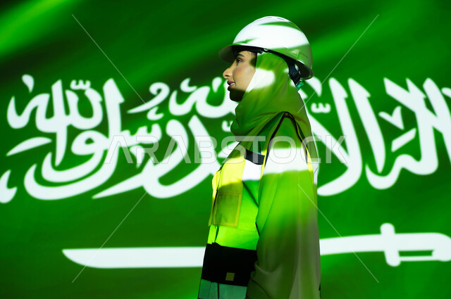 Women's professions and jobs, the prosperity of the engineering sector with the help of the people of the country, a close-up picture from the side of a veiled Saudi Arabian Gulf engineer wearing a jacket and a protective helmet, the merging of the body with the light of science, Saudi Flag Day, March 11, celebrating the anniversary of the Saudi National Day, September 23, and the National Day.