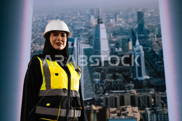 Gestures of pride and pride in the urban renaissance of the Kingdom, Saudi national construction projects, a veiled Saudi Arab Gulf engineer wearing a helmet and a protection jacket standing tall, building the nation with the help of its sons and engineer