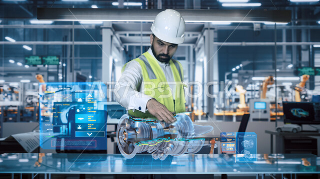 مصانع سيارات سعودية متطورة معتمدة على الذكاء الاصطناعي، الكفاءة في التصنيع والإنتاج وتحقيق الثورة الصناعية، التطور والتحول التقني الحديث، مهندس عربي خليجي سعودي يرتدي الخوذة وسترة الحماية يقوم بمعاينة محرك مصنوع بتقنية الهولوجرام، رؤية مستقبلية 2030