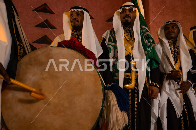 صورة مقربة لدق الطبول في عروض الفلكلور التراثي، الأهازيج في المناسبات الوطنية ، فرقة العرضة الحجازية امام المتحف الوطني في الرياض، ارتداء زي الدقلة والفرميلة الشعبية، ذكرى اليوم الوطني السعودي في 8 ربيع الاول، الاحتفال بيوم العلم السعودي 11 مارس