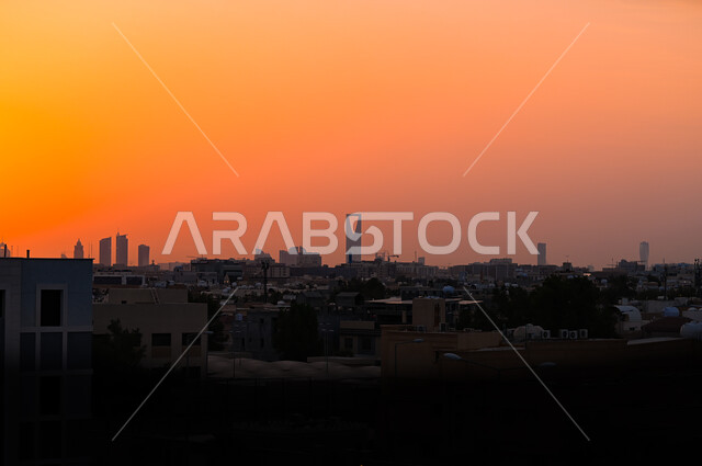 A panoramic picture of the city of Riyadh at sunset, the growth and urban development of neighborhoods and residential buildings in Saudi Arabia, the architectural art of towers and skyscrapers, the famous landmarks of Riyadh