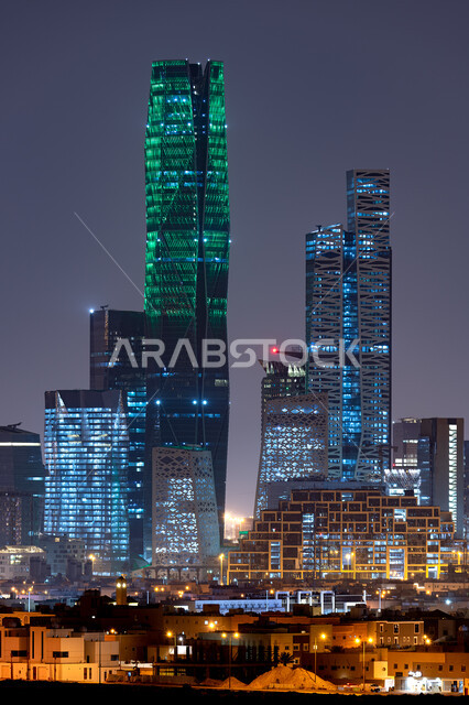Urban growth and development of the financial towers and economic establishments illuminated at night in the city of Riyadh, King Abdullah Financial District (KAFD), the architectural art of the towers and skyscrapers in the Kingdom of Saudi Arabia, the f