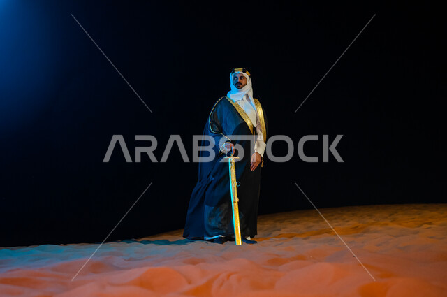 The concept of guarding and watching at night, a close-up depiction of a Saudi Arabian Gulf man wearing a ghutra and bisht and holding a sword in his hand outside at night time, standing proudly and confidently in the Saudi state, contemplating and lookin