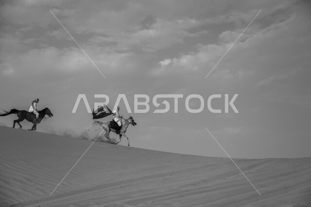 Horse racing in the desert, Saudi National Day, National Day September 23, Flag Day celebration March 11, a black and white picture of two Saudi Arabian Gulf horsemen wearing the shemagh and traditional dress racing in the desert, the strength and originality of the Arabian horse