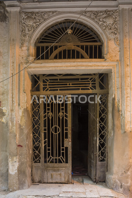 An iron door for the entrance of an old building, the ancient Arab architectural design of buildings and streets, the ancient buildings in the historical village in the city of Jeddah, tourist places and historical heritage monuments in the Kingdom of Sau