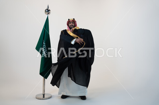 مؤسس الدوله السعوديه الاولى الامام محمد بن سعود، تأسيس المملكة العربية السعودية  1727 م، ذكرى اليوم الوطني السعودي 23 سبتمبر، يوم العلم 11 مارس، بورتريه لرجل عربي خليجي سعودي يرتدي البشت والشماغ يقف بجانب البيرق، صورة الجسم بالطول الكامل، خلفية بيضاء