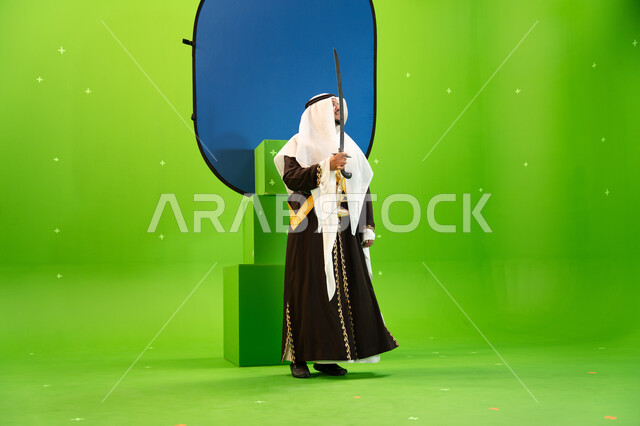 Celebrating the anniversary of the founding of the first Saudi state, February 23, by performing the Najdi parade, showing the heritage of the southern region, using swords in folk dance, wearing costumes for national occasions, Saudi traditional folklore
