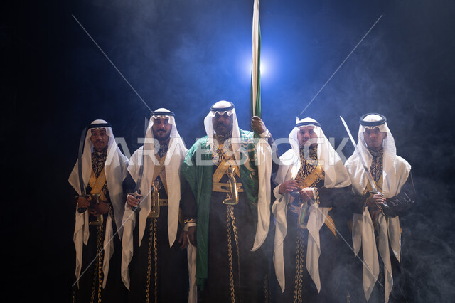 Wearing the popular Najdi parade costume, pride in Saudi identity, traditional folklore performance troupe on National Day on the 8th of Rabi’ al-Awwal, celebrating Flag Day on March 11, folk dancing with swords and chants and celebrations on national occ