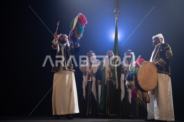 إظهار الولاء والحب للدولة السعودية, فرقة عروض الفلكلور التراثي في العيد الوطني في 23 سبتمبر، الاحتفال بيوم العلم السعودي في 11 مارس, ارتداء زي العرضة النجدية الشعبية، الرقص الشعبي والاحتفالات في المناسبات الوطنية, خلفية سوداء مع إضاءة بيضاء