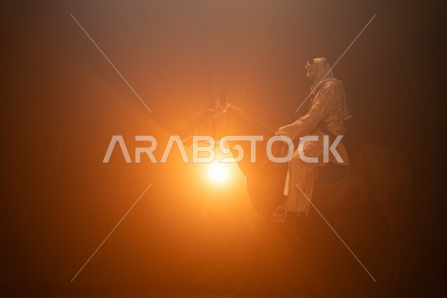 Practicing the hobby of horse riding, wearing costumes for national occasions and holidays, commemorating the founding of the first Saudi state in 1727 AD, Saudi Founding Day, February 22, a side photo of a Gulf man wearing a daghla and ghutra riding his 