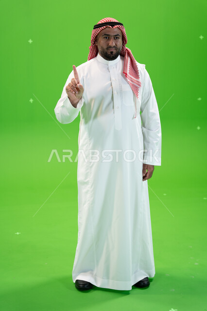3D hologram technology, portrait of a Saudi Arabian Gulf man in traditional dress using the sense of touch to move holographic elements, two hand gestures indicating something, full length body image, green background, chroma