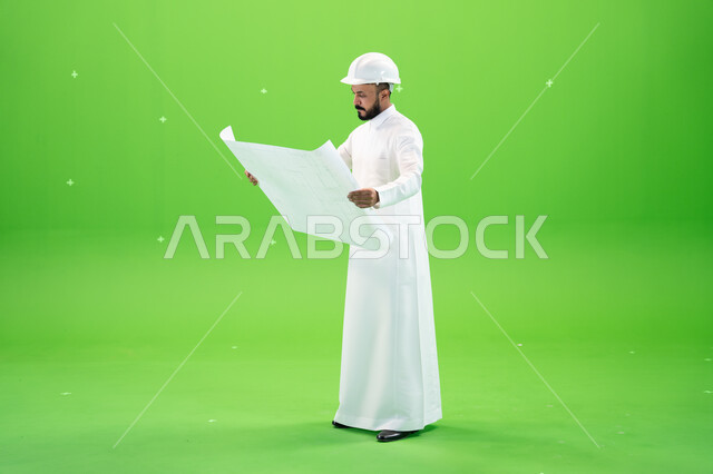 Managing engineering tasks and projects, Saudi crafts and professions, auditing the construction plan, portrait of a Saudi Gulf Arab engineer wearing a traditional dress and a protective helmet at the work site, full-length body portrait, green background