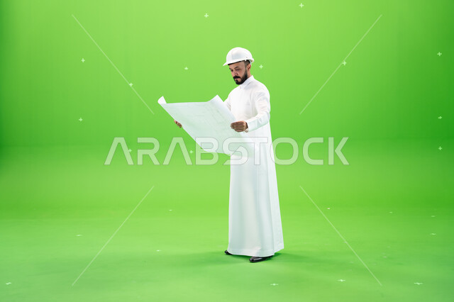 Managing engineering tasks and projects, Saudi crafts and professions, auditing the construction plan, portrait of a Saudi Gulf Arab engineer wearing a traditional dress and a protective helmet at the work site, full-length body portrait, green background