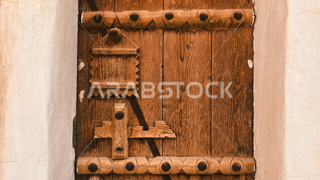Historical houses in the city of Riyadh, ancient Arab architectural design of ancient antique wooden doors, architectural engineering art of ancient mud buildings in the village of Ushaiqar in Al-Shaqra Governorate, famous heritage tourist places in Saudi