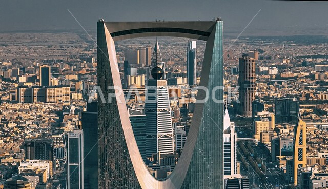 Urban growth and development in towers and skyscrapers in Saudi Arabia, a close-up of the Kingdom Tower and behind it the Al-Faisaliah Tower in the city of Riyadh, architectural engineering art of the famous buildings, facilities and landmarks of Riyadh