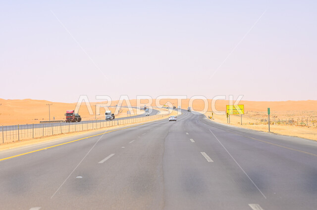 Car traffic on a desert road in the Kingdom, the highway connecting Riyadh and Qassim, asphalt roads and streets in natural desert areas in Saudi Arabia.