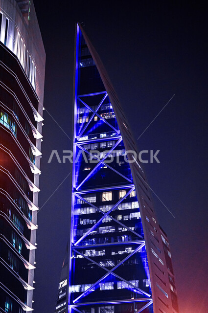 A close-up photo of the illuminated Hamad Tower at night in the city of Riyadh, the architectural art of towers and skyscrapers, urban growth and development in Saudi Arabia, the famous landmarks of Riyadh