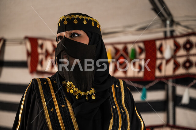 ارتداء أزياء المناسبات الوطنية, الوقوف والتأمل بإيماءات الفخر والاعتزاز، صورة مقربة لإمرأة عربية خليجية سعودية ترتدي العباءة و البرقع الأسود تنظر إلى شيء ما ، ذكرى يوم التأسيس السعودي في 22 فبراير، تأسيس الدولة السعودية الأولى 1727 م