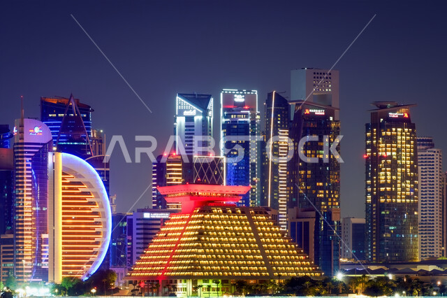 The development of Arab buildings and engineering monuments, the importance of the role of tourism in the city of Qatar, enjoying the quiet atmosphere at night, skyscrapers in Doha, the architectural art of the Dafna towers illuminated at night, famous tourist places and regions