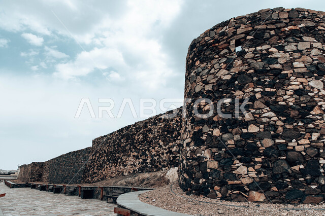 Famous tourist places in Saudi Arabia in broad daylight, archaeological heritage tourist attractions in the historic Shamsan Castle, the building made of stones and trunks of juniper trees, the ancient architectural design of fortified military castles in the city of Abha in the Asir region