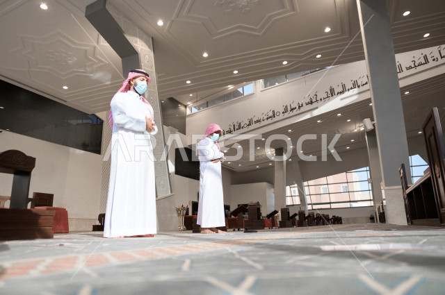Performing the obligatory prayer inside the mosque, the congregation prayed for two Saudi men wearing the muzzle, keeping the distance between them, adhering to preventive measures, worshiping and getting close to God