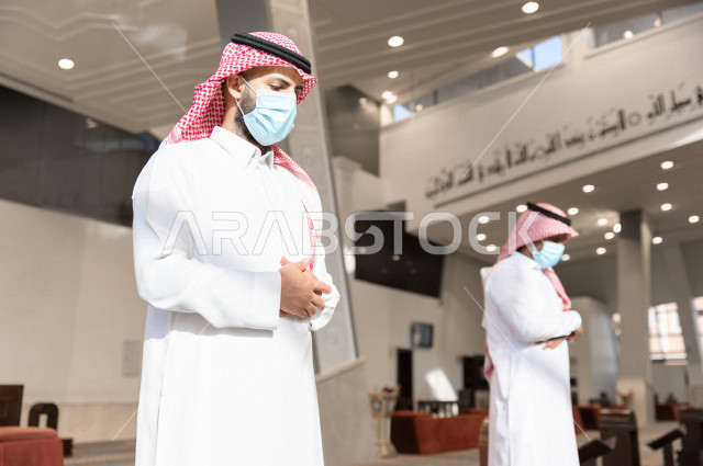 Performing the obligatory prayer inside the mosque, the congregation prayed for two Saudi men wearing the muzzle, keeping the distance between them, adhering to preventive measures, worshiping and getting close to God