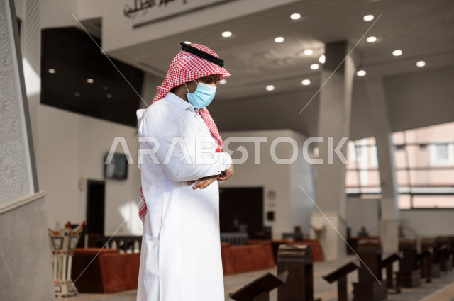 Performing the obligatory prayer inside the mosque, a Saudi man prays and wears a mask, adherence to preventive measures, worship and draw close to God